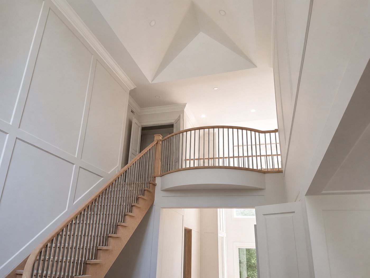 Double-height foyer with panelled walls and interior doors