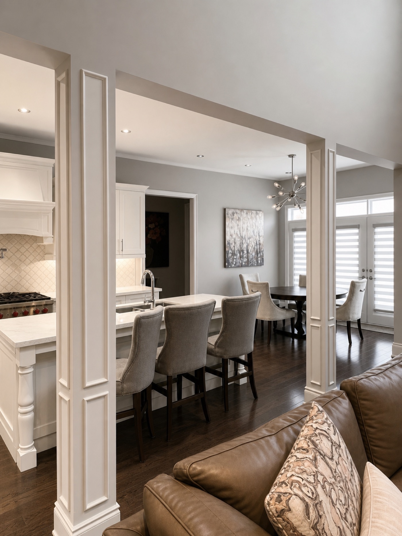 Open-plan kitchen and dining room with trimmed columns, wainscoting, and crown moulding by R2 WoodWork