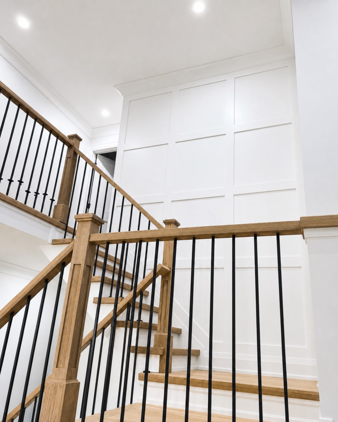 Panelled stair wall with wood railing