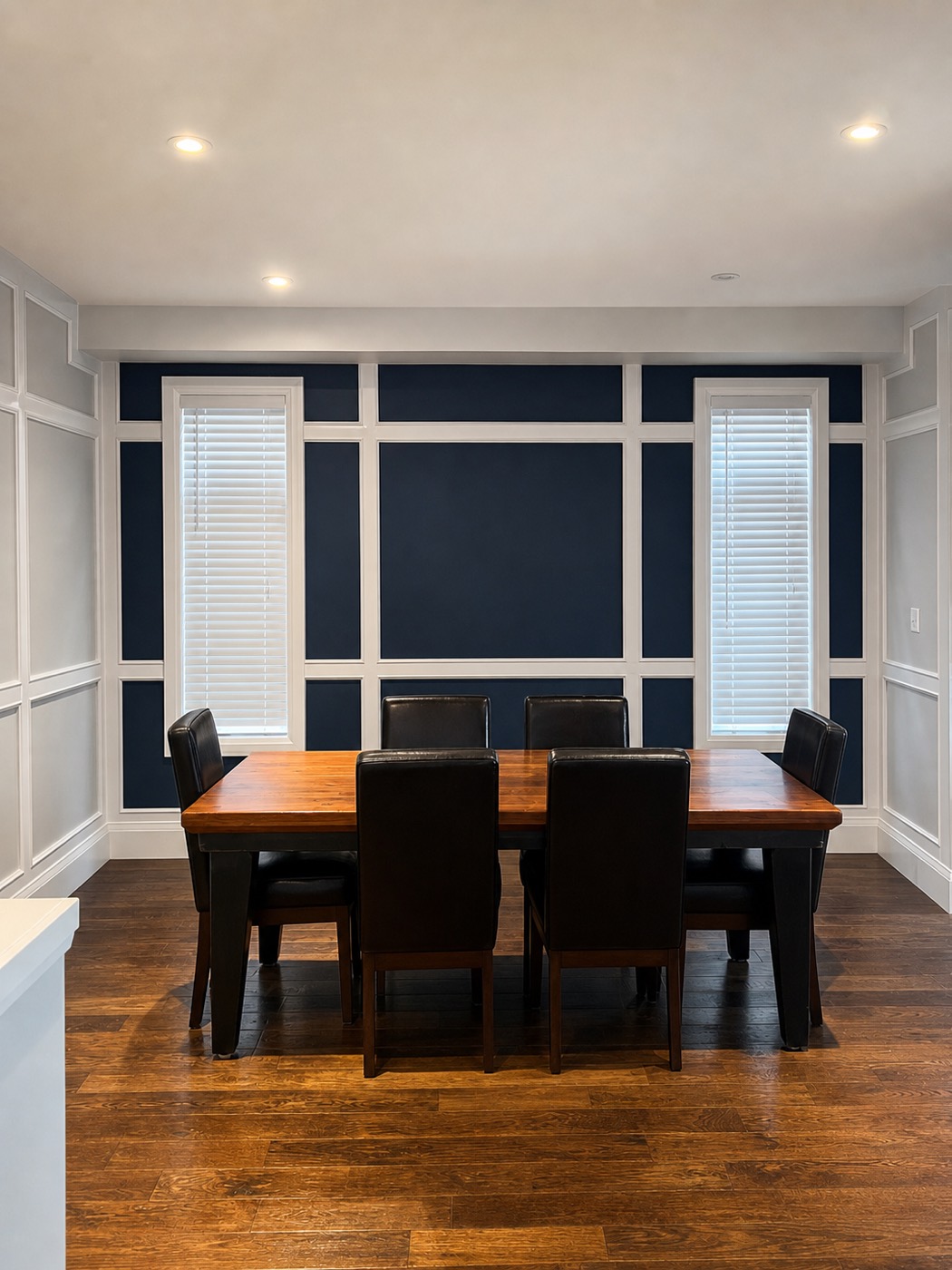 Navy dining room with white panel trim