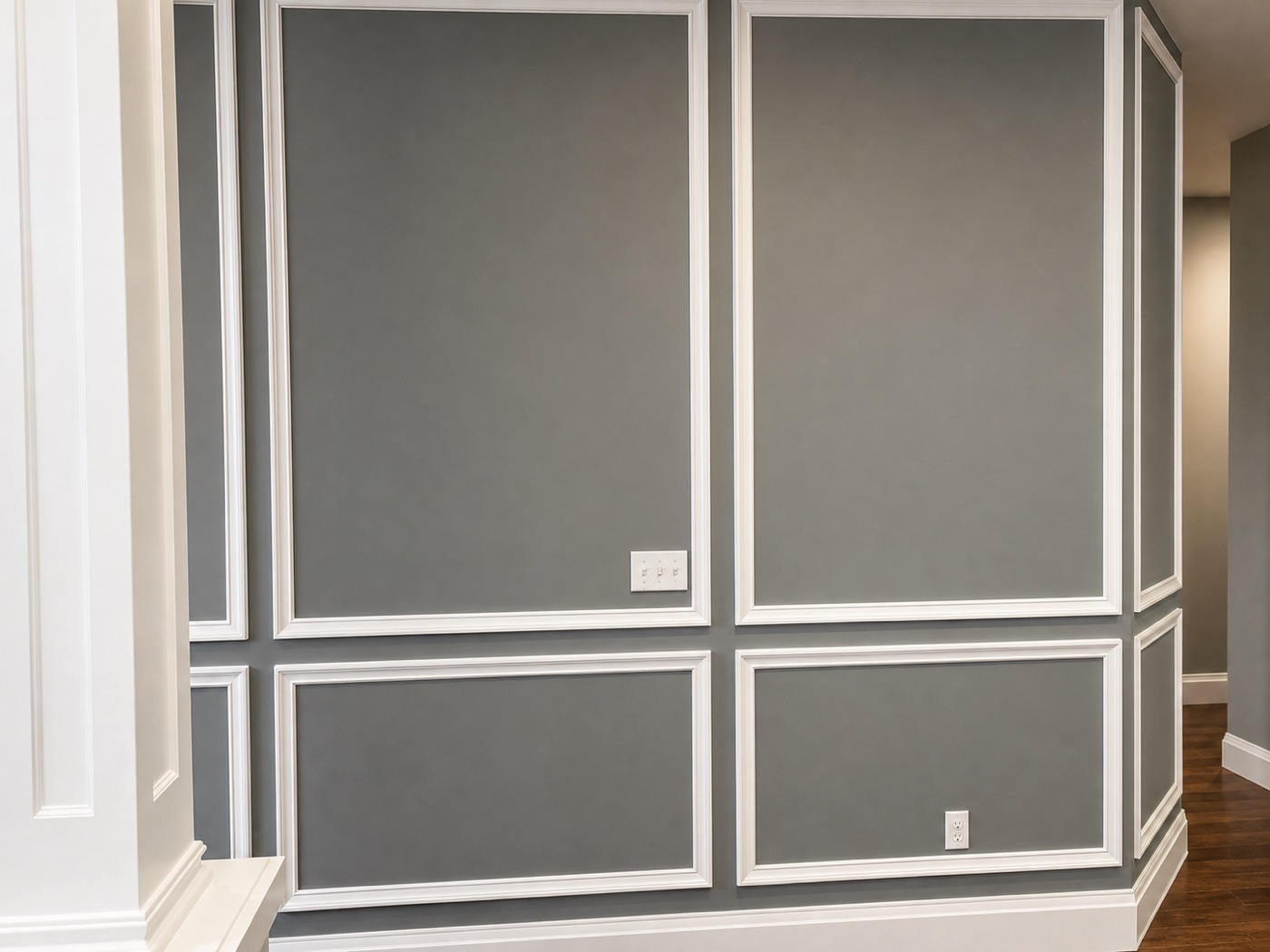 Grey picture-frame wainscoting wrapping a corner