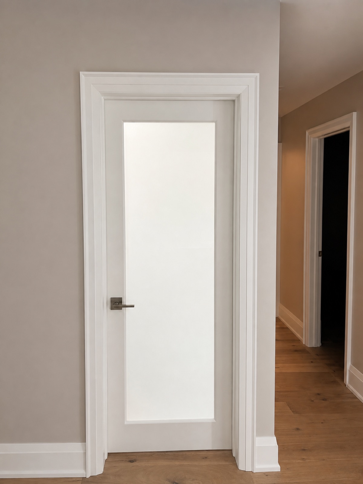 White frosted-glass interior door with clean casing