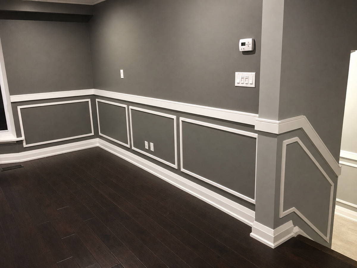 Grey room with white panel trim and baseboards