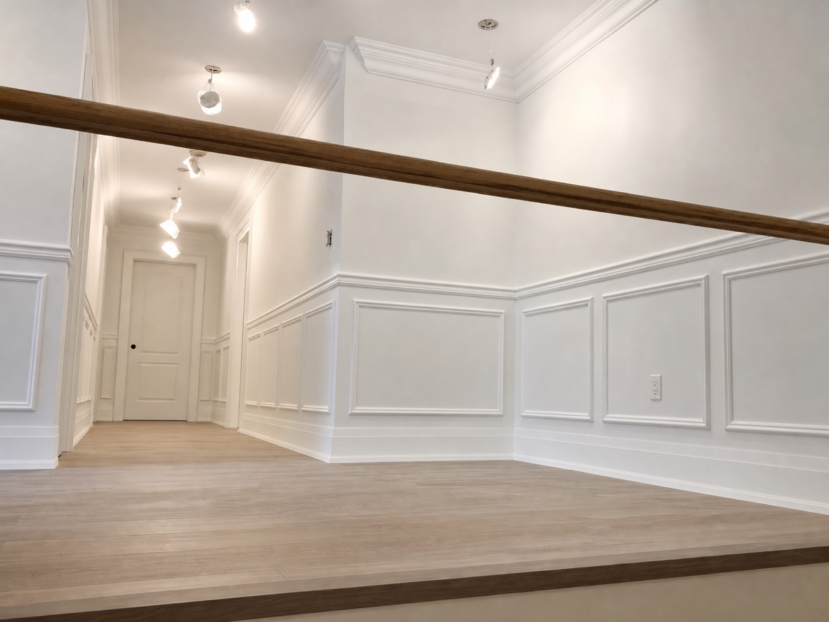 White picture-frame wainscoting with a wood beam