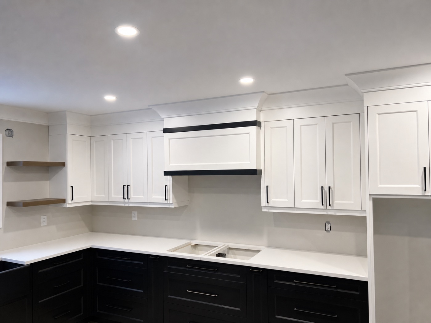 Kitchen cabinets and range hood meeting the ceiling line